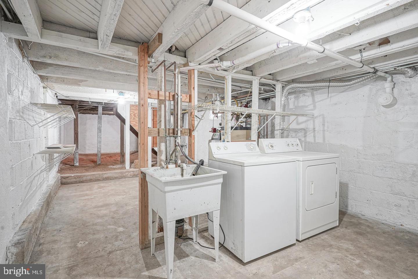 89 Main Street Bridgeport, NJ 08014 - Photo 15 of 15 a utility room with a sink dryer and washer