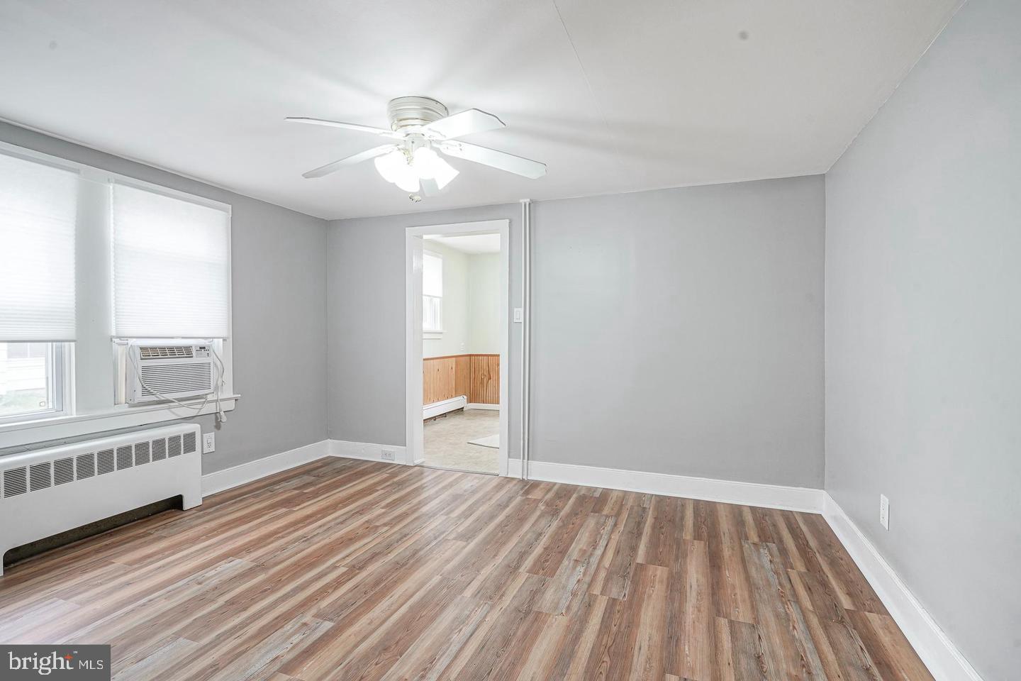 89 Main Street Bridgeport, NJ 08014 - Photo 4 of 15 a view of an empty room with wooden floor and a window