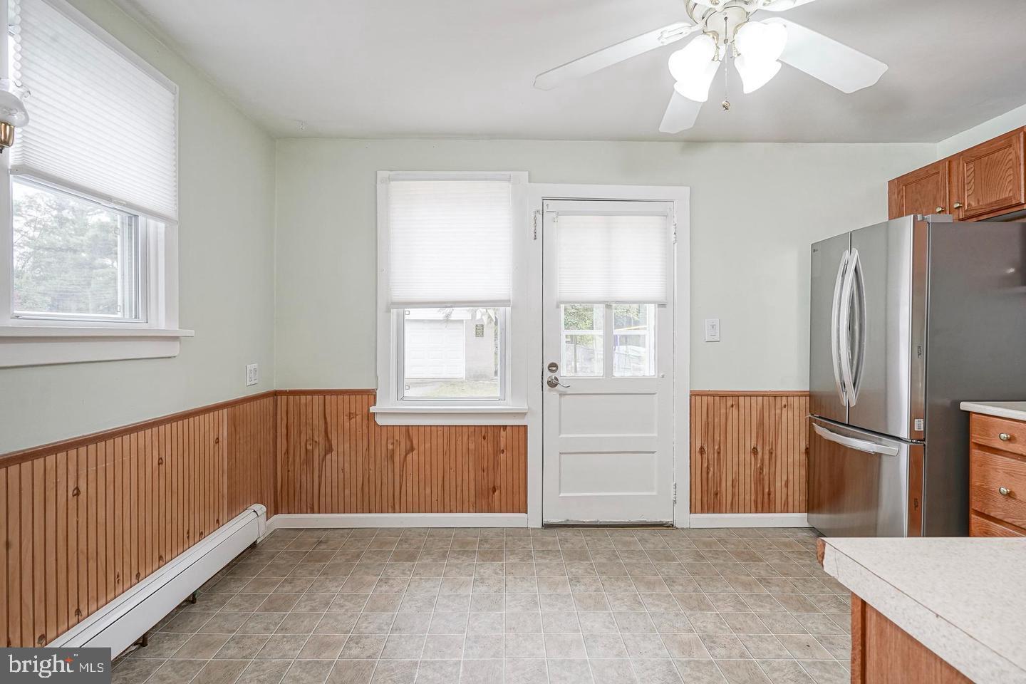 89 Main Street Bridgeport, NJ 08014 - Photo 6 of 15 an empty room with windows cabinet and fire place