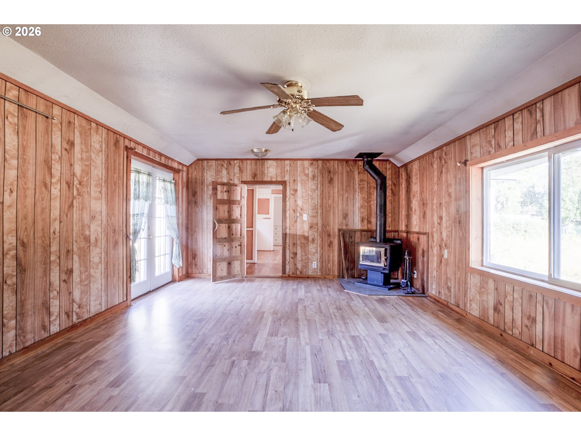 47433 School Street Oakridge, OR 97463 - Photo 2 of 16 wooden floor in an empty room with a window
