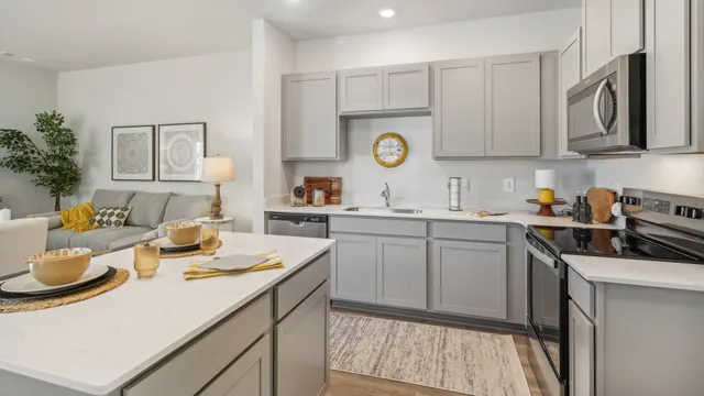 a kitchen with a sink a stove and cabinets