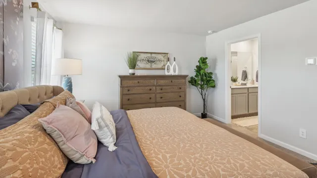 a bedroom with a bed and a dresser