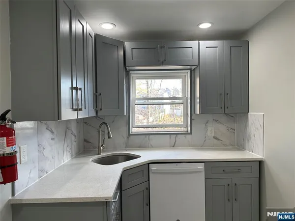 a kitchen with a sink window and cabinets