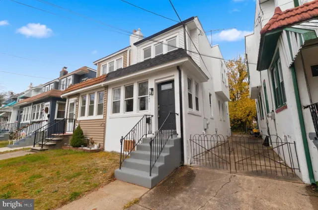 a view of a house with a wooden fence