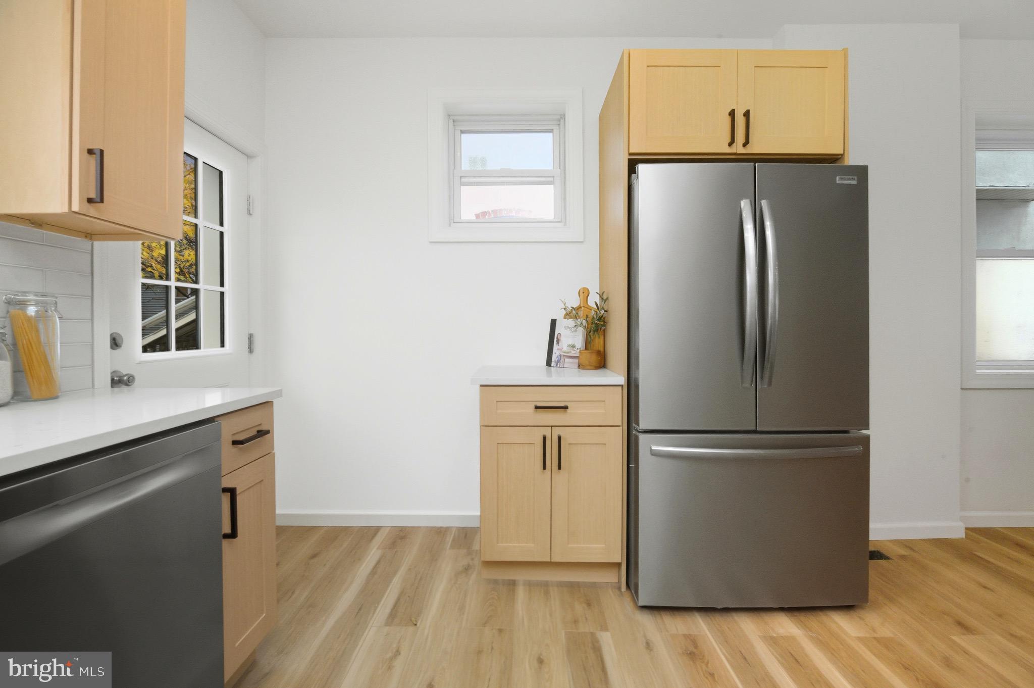 2446 46th Street Pennsauken, NJ 08110 - Photo 11 of 25 a kitchen with a refrigerator a sink and cabinets
