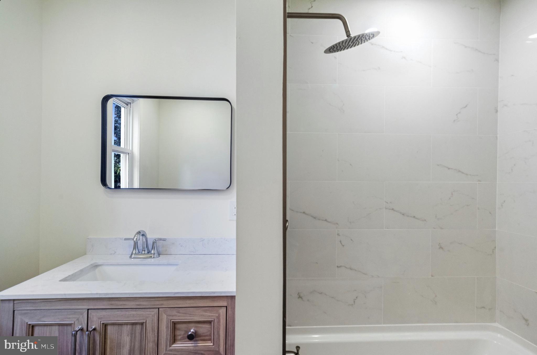 2446 46th Street Pennsauken, NJ 08110 - Photo 13 of 25 a bathroom with a granite countertop sink and a mirror