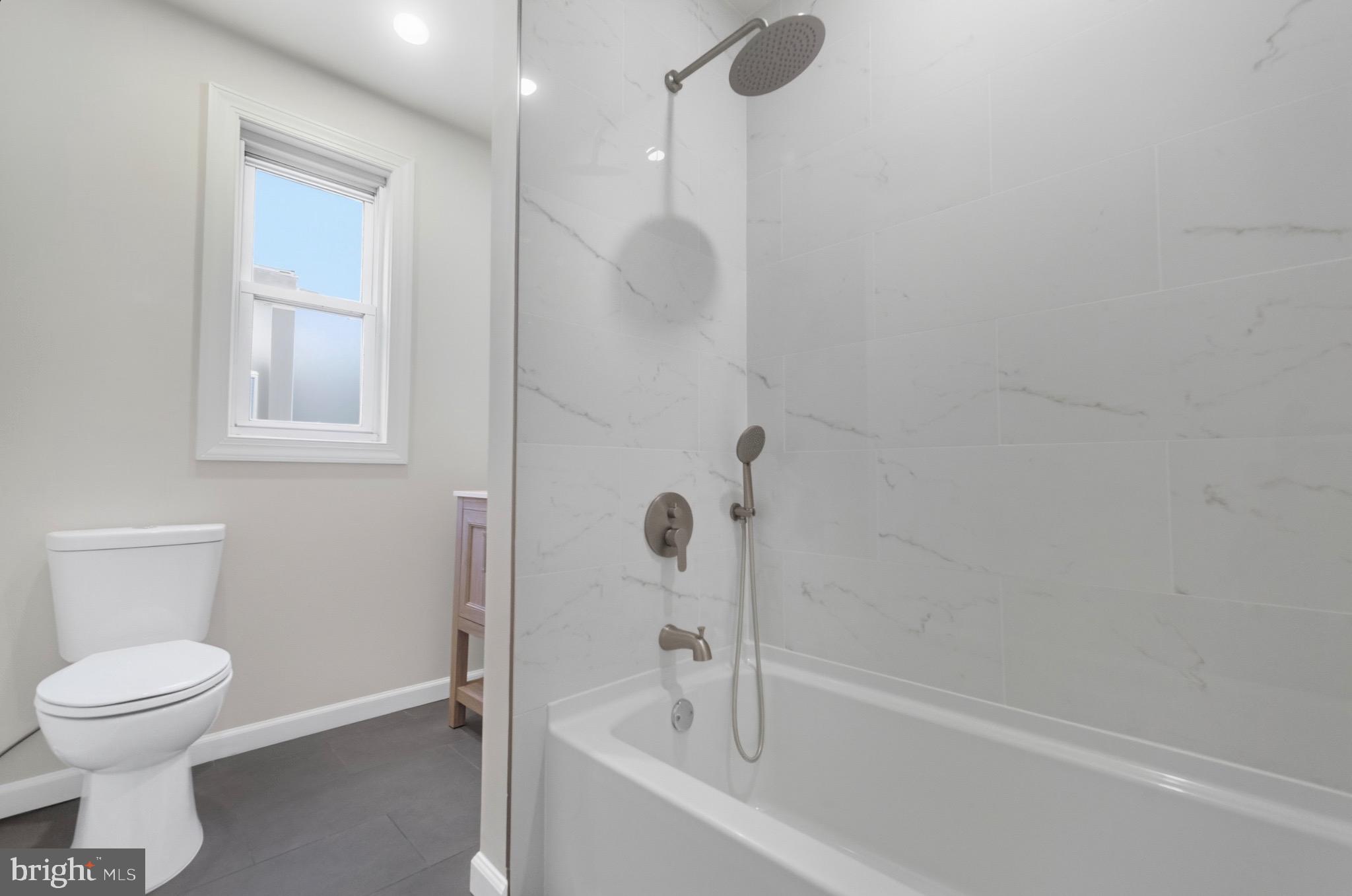 2446 46th Street Pennsauken, NJ 08110 - Photo 14 of 25 a bathroom with a toilet and a bathtub
