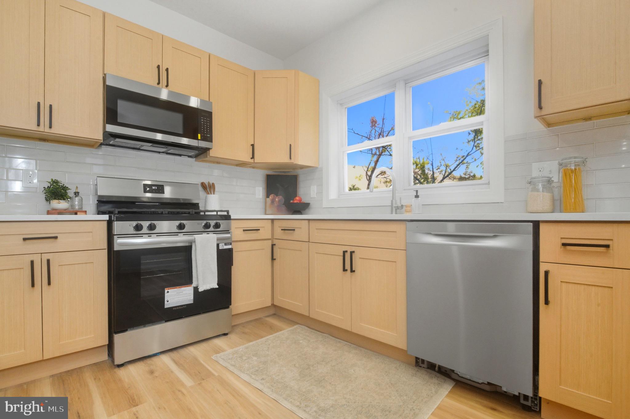 2446 46th Street Pennsauken, NJ 08110 - Photo 10 of 25 a kitchen with white cabinets and stainless steel appliances