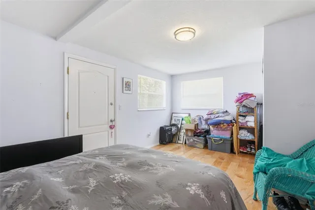 a bedroom with a bed and a potted plant