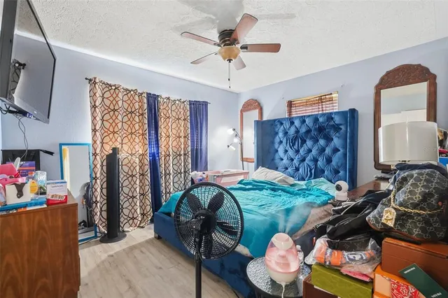 a bedroom with furniture and a flat screen tv