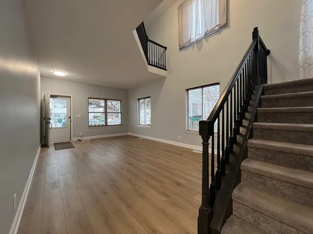 a view of an entryway with wooden floor and stairs