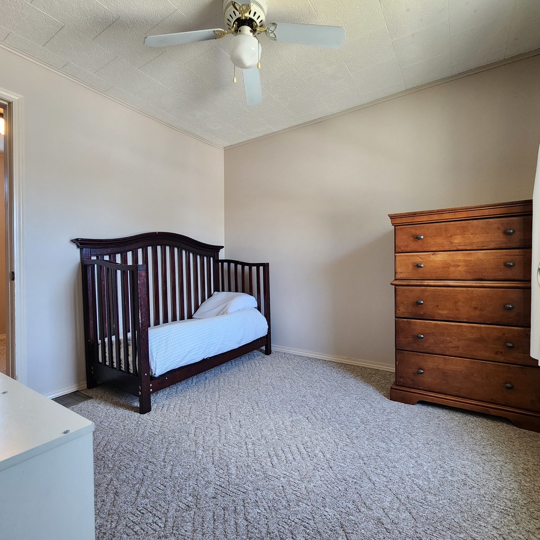 700 West Lafayette Street Ottawa, IL 61350 - Photo 18 of 24 a bed room with a bed and a dresser