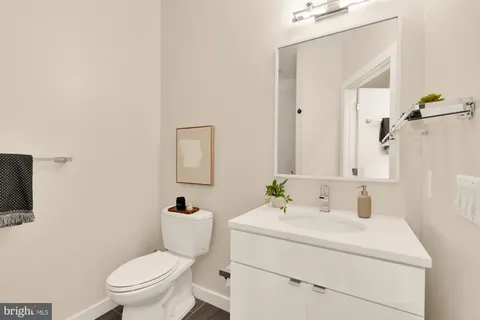a bathroom with a sink toilet and mirror