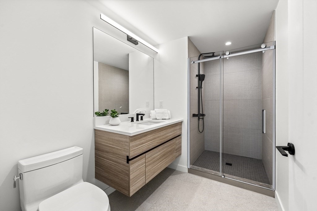 1395 Washington Street, Unit 401 Boston, MA 02118 - Photo 18 of 27 a bathroom with a sink toilet and shower