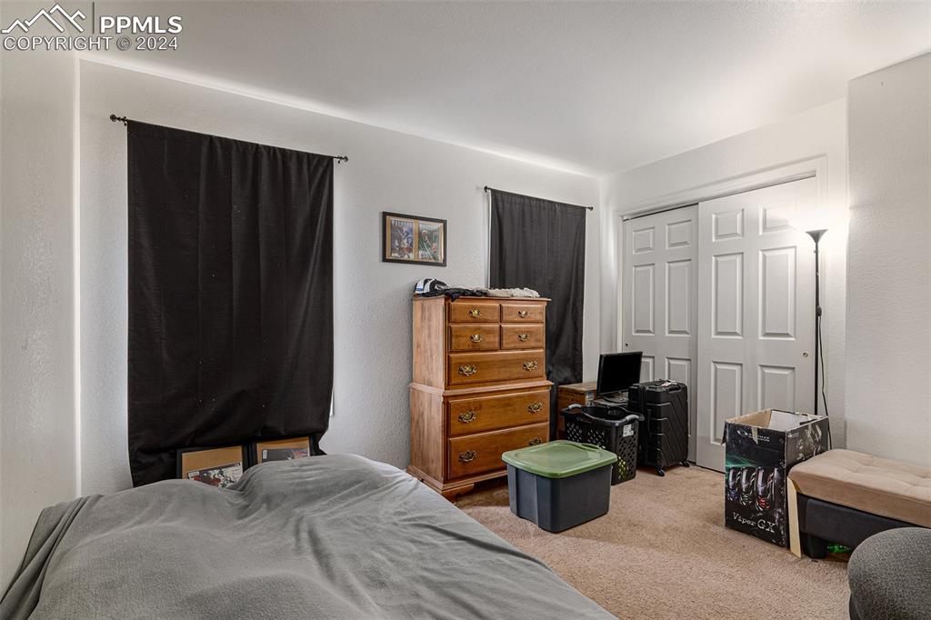 4400 Rawhide Road, Unit 159 Pueblo, CO 81008 - Photo 16 of 22 a bedroom with furniture and a potted plant