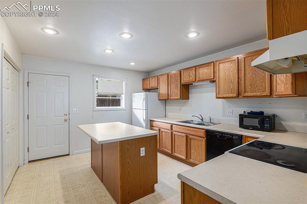 4400 Rawhide Road, Unit 159 Pueblo, CO 81008 - Photo 9 of 22 a kitchen that has a sink and a stove in it