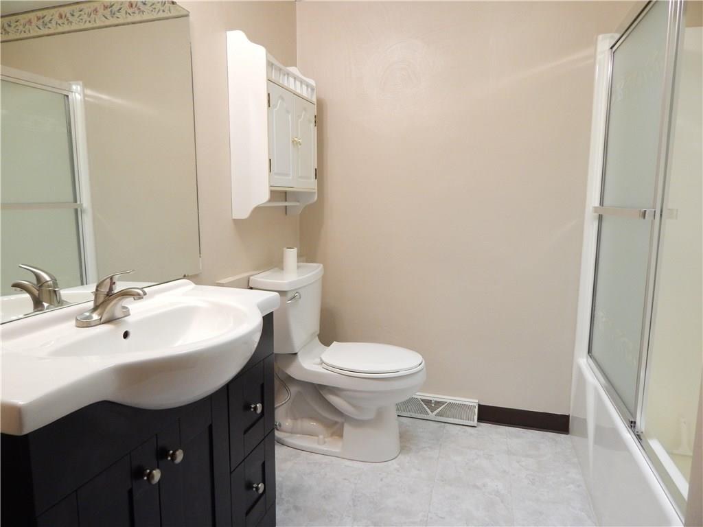 76 Fulton Road Canonsburg, PA 15317 - Photo 12 of 25 The Master Bathroom has vinyl flooring, white fixtures and a contemporary vanity. There are also slider doors to the tub surround.