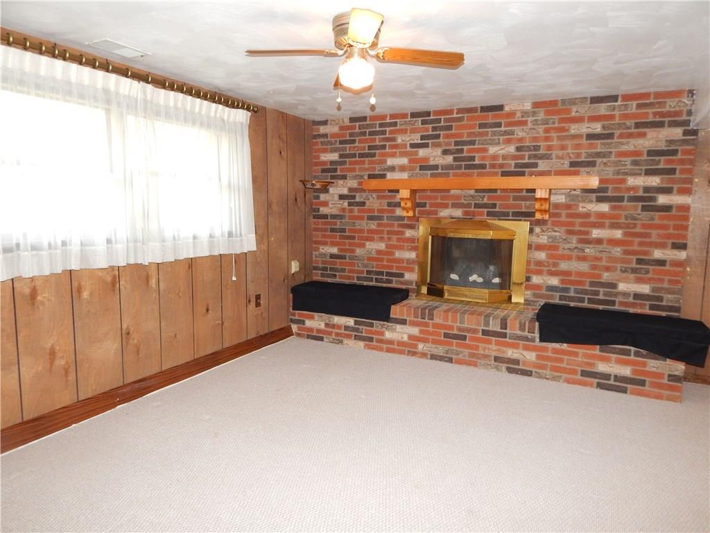 76 Fulton Road Canonsburg, PA 15317 - Photo 16 of 25 The lower level Game Room has a solid wood mantle above the fireplace. The fireplace is covered with a brass enclosure.