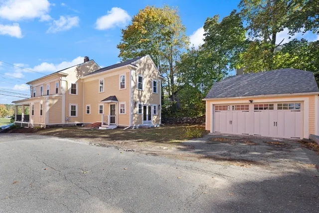 a view of a house with a yard and garage