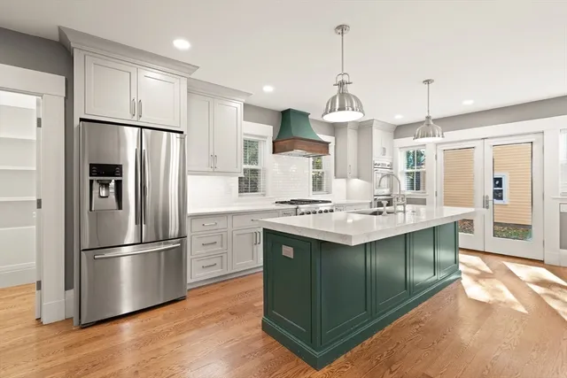 a kitchen with stainless steel appliances granite countertop a sink stove and refrigerator