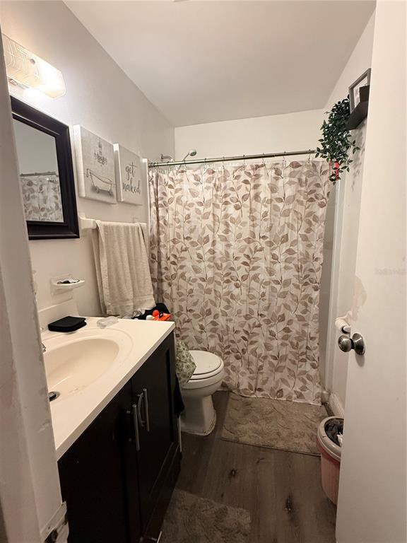 1805 Michigan Avenue, Unit D Kissimmee, FL 34744 - Photo 6 of 9 a bathroom with a sink toilet and shower
