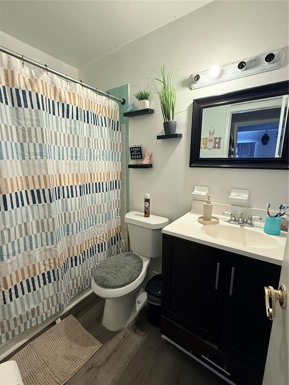 1805 Michigan Avenue, Unit D Kissimmee, FL 34744 - Photo 8 of 9 a bathroom with a sink toilet and mirror