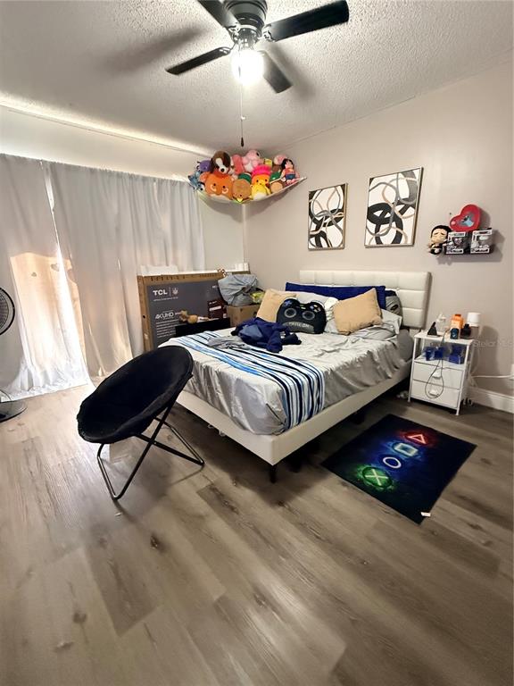 1805 Michigan Avenue, Unit D Kissimmee, FL 34744 - Photo 9 of 9 a bedroom with a bed and a chandelier