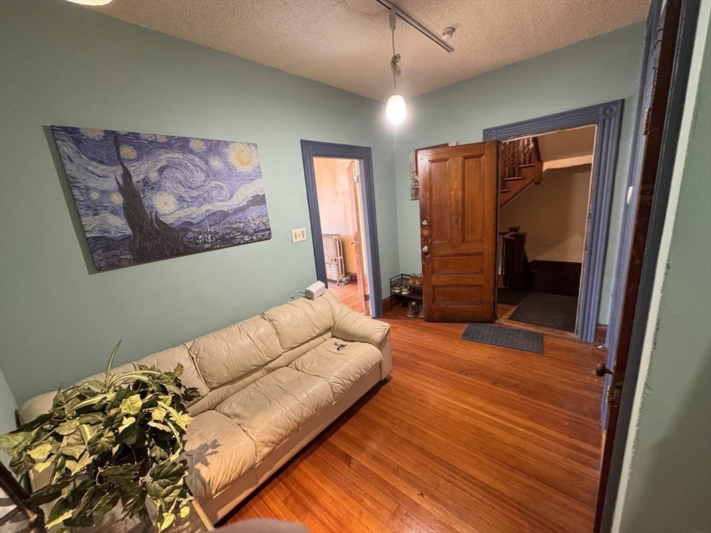 472 Warren Street Boston, MA 02121 - Photo 11 of 42 a bedroom with a bed and a painting on the wall