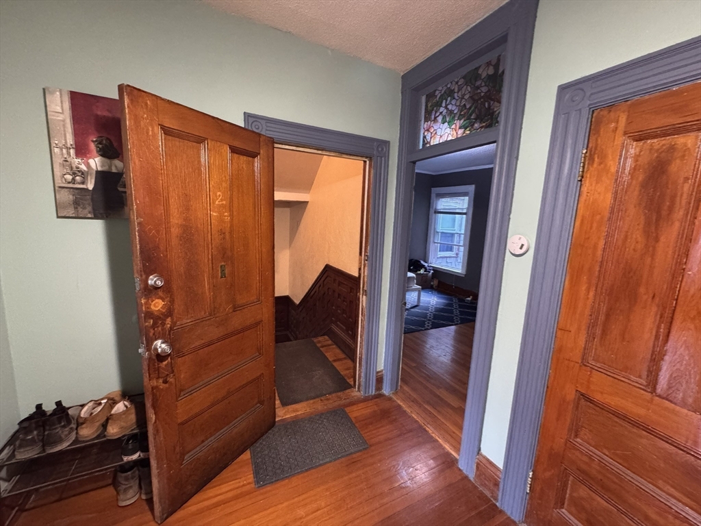 472 Warren Street Boston, MA 02121 - Photo 18 of 42 a view of an entryway with wooden floor and a bedroom