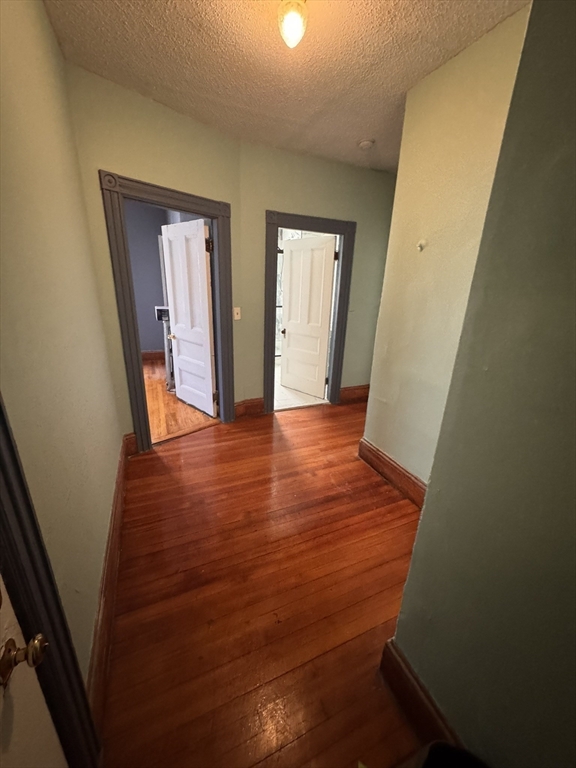 472 Warren Street Boston, MA 02121 - Photo 19 of 42 wooden floor in an empty room