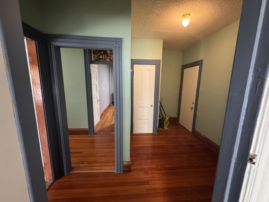 472 Warren Street Boston, MA 02121 - Photo 22 of 42 a view of a hallway with wooden floor