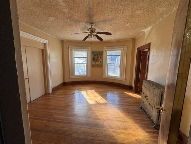 472 Warren Street Boston, MA 02121 - Photo 27 of 42 a view of empty room with wooden floor and fan