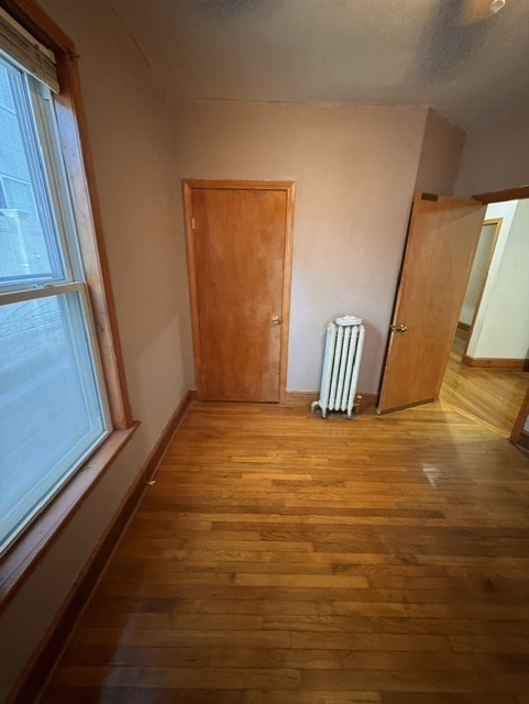 472 Warren Street Boston, MA 02121 - Photo 34 of 42 a view of an empty room with wooden floor and a window