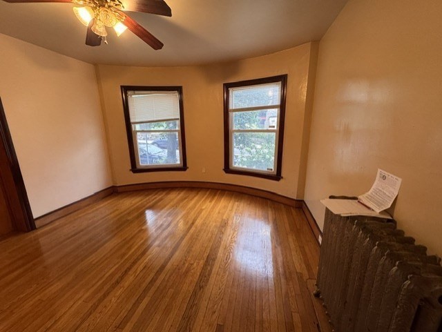472 Warren Street Boston, MA 02121 - Photo 37 of 42 a view of an empty room with wooden floor and a window
