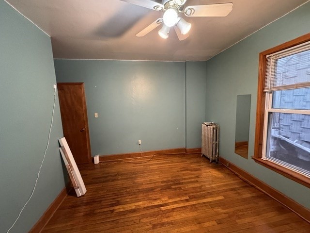 472 Warren Street Boston, MA 02121 - Photo 40 of 42 a view of an empty room with window and wooden floor
