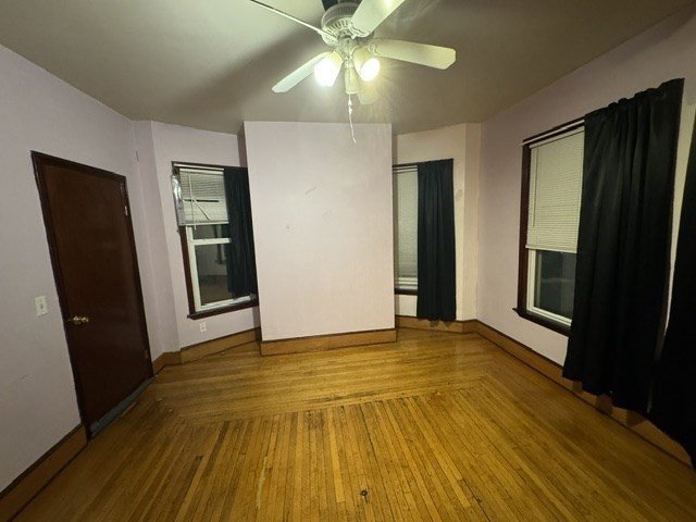 472 Warren Street Boston, MA 02121 - Photo 42 of 42 a view of an empty room with window and wooden floor