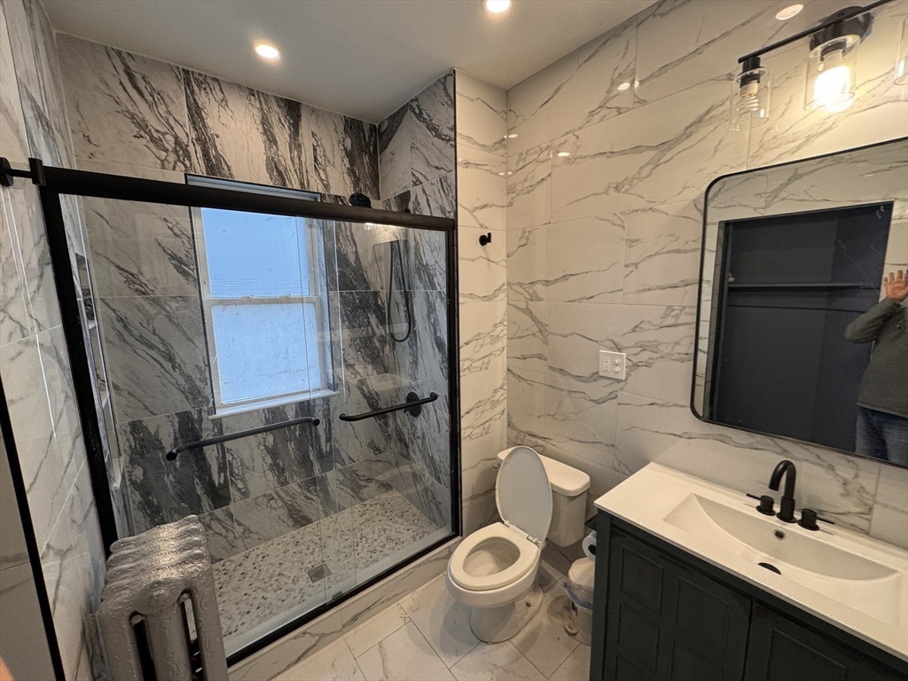 472 Warren Street Boston, MA 02121 - Photo 10 of 42 a bathroom with a sink a toilet and shower
