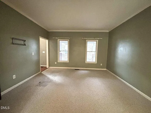 a view of an empty room with windows