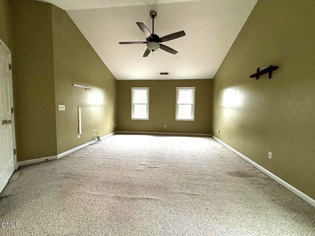 a view of a livingroom with a ceiling fan and window