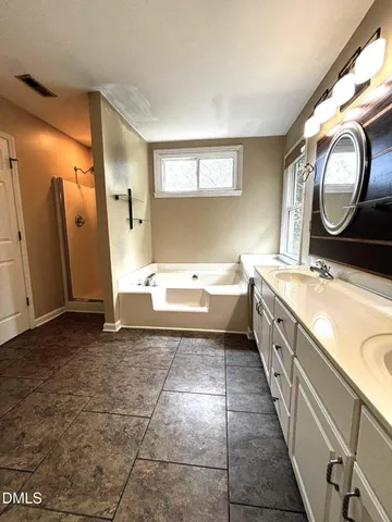a bathroom with a double vanity sink and a mirror