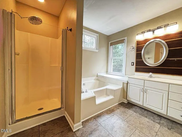 a bathroom with a sink a mirror and a shower