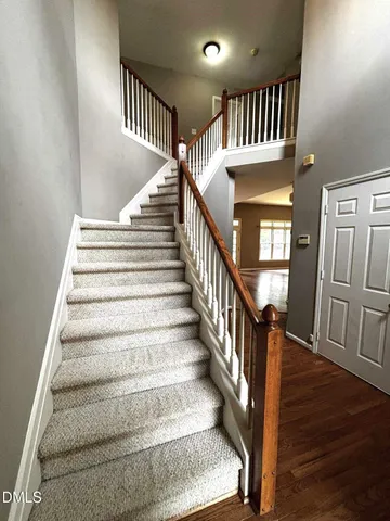 a view of staircase with lots of frames and wooden floor