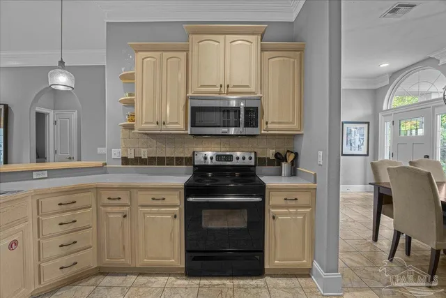 a kitchen with granite countertop a stove top oven microwave and cabinets