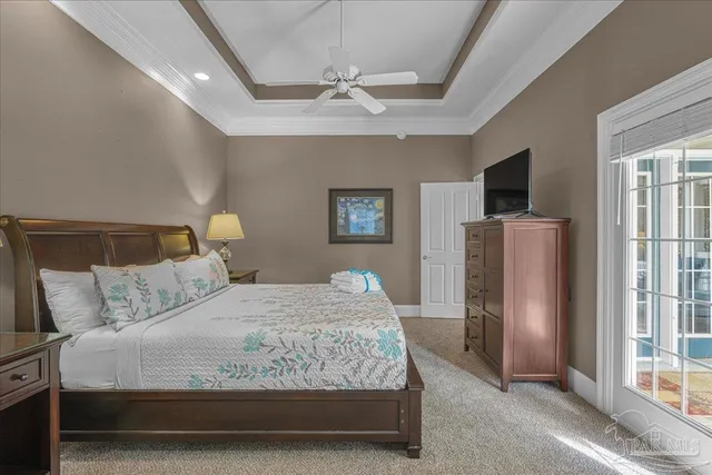 a bedroom with a bed mirror and window