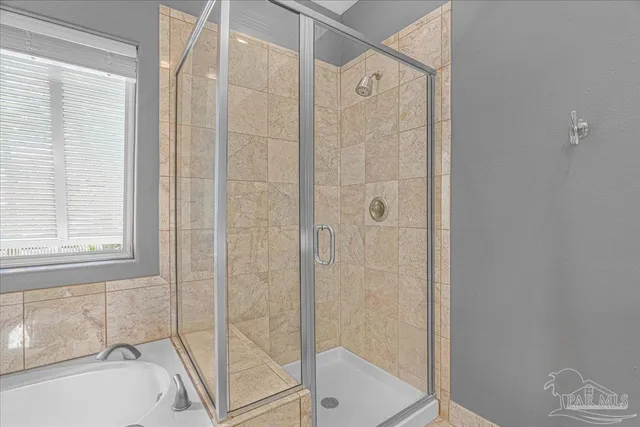 a bathroom with a bathtub and a shower