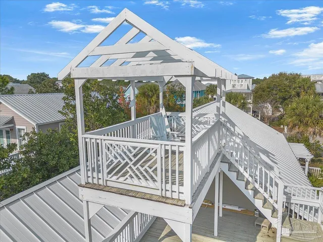 a view of balcony with wooden floor and fence