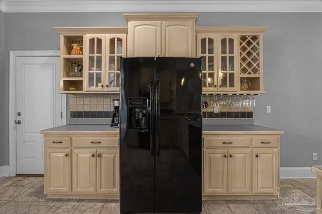 a kitchen with a refrigerator and cabinets