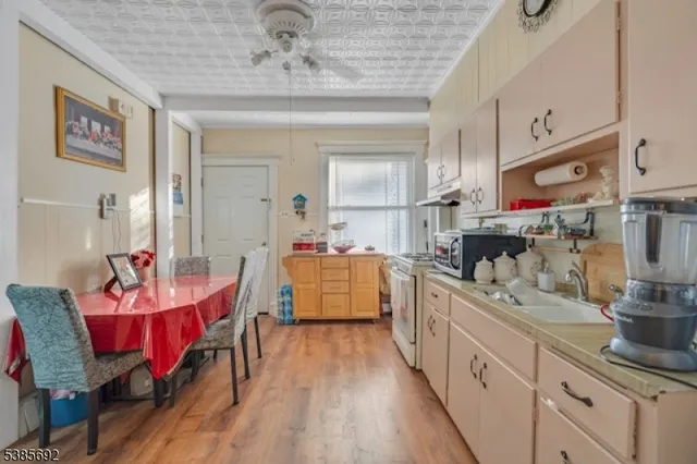 a large kitchen with a table and chairs