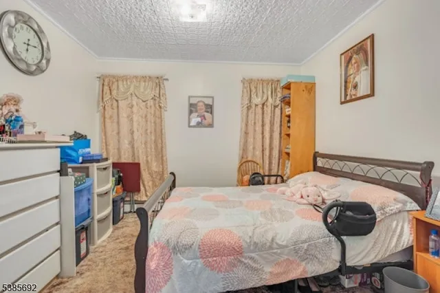 a bedroom with a bed and a table in it with window