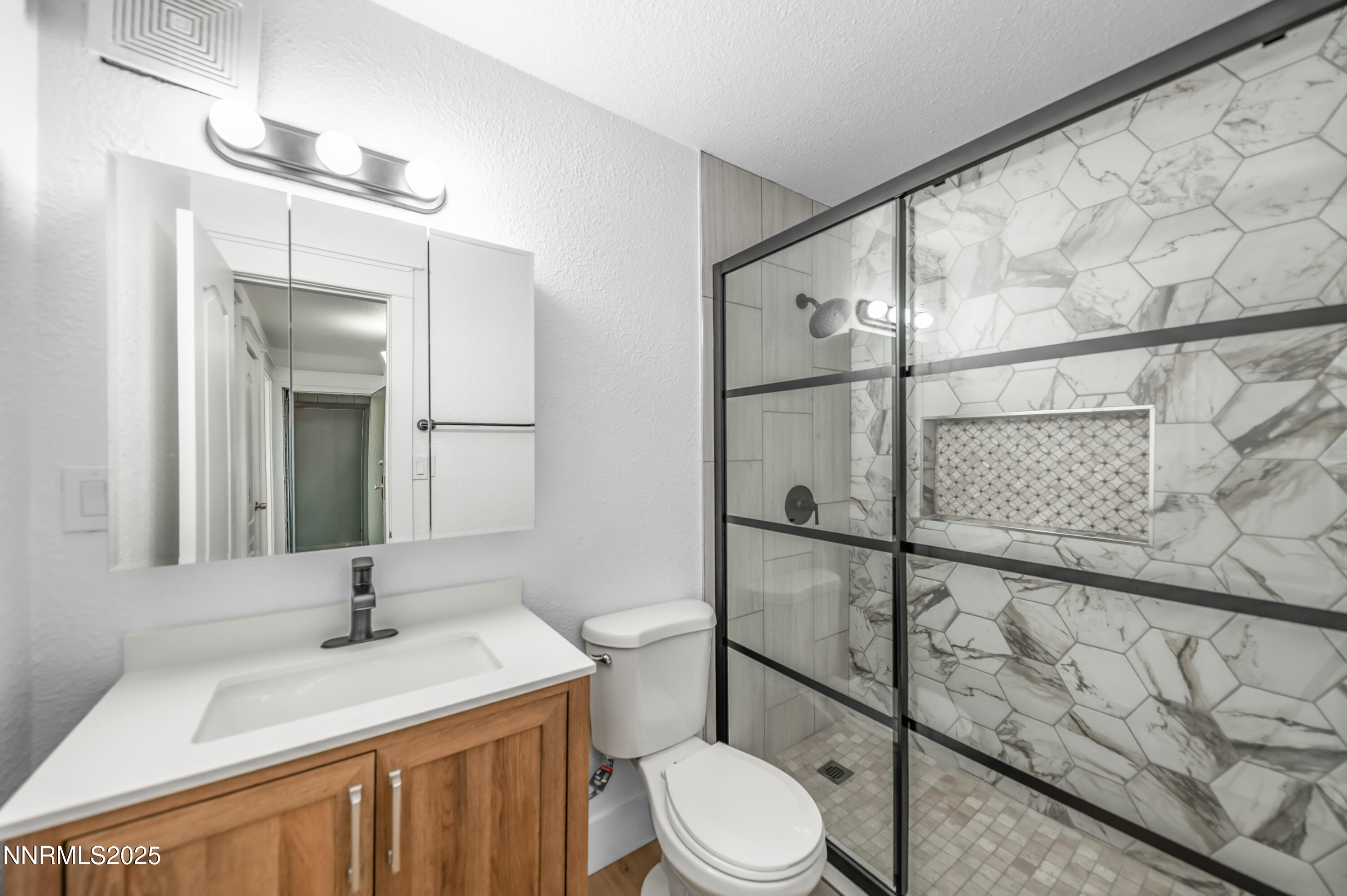 3953 Clear Acre Lane, Unit 305 Reno, NV 89512 - Photo 18 of 22 a bathroom with a granite countertop sink toilet and shower